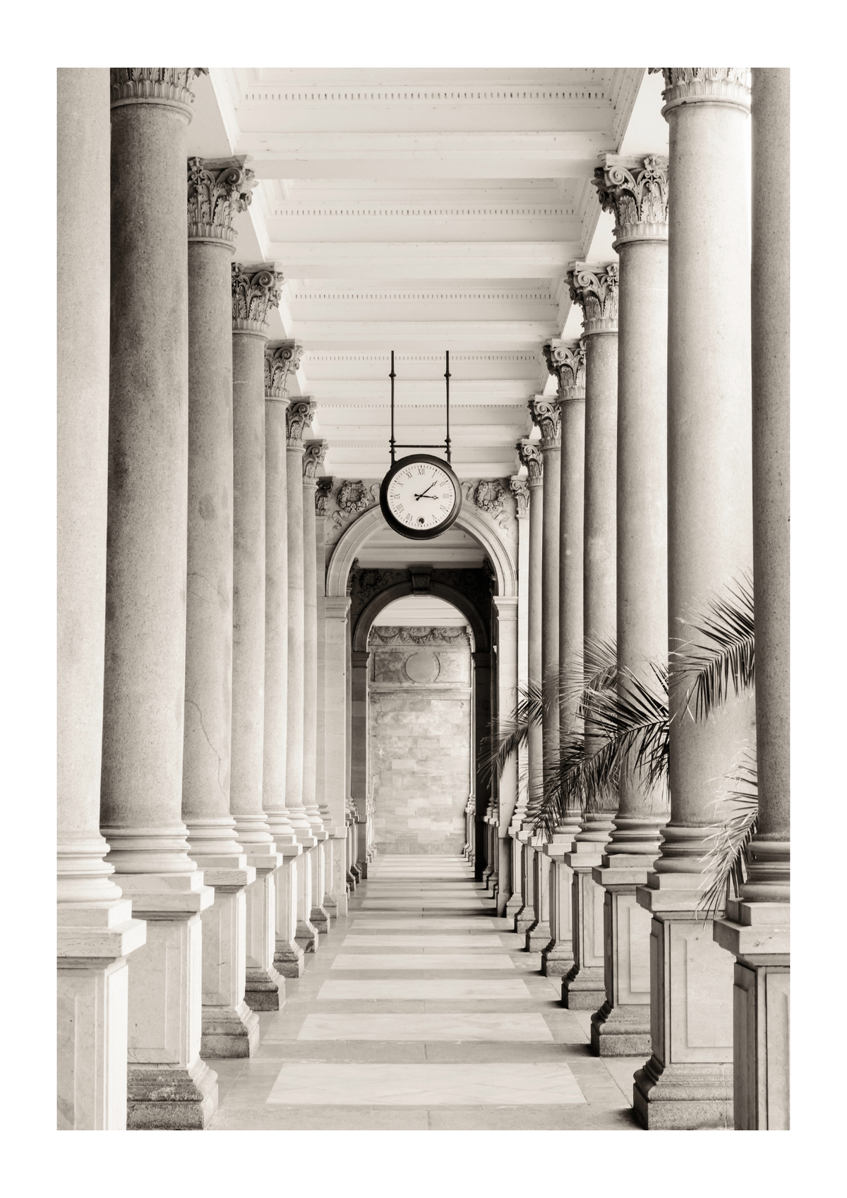 pillars and palm leaves and a clock.