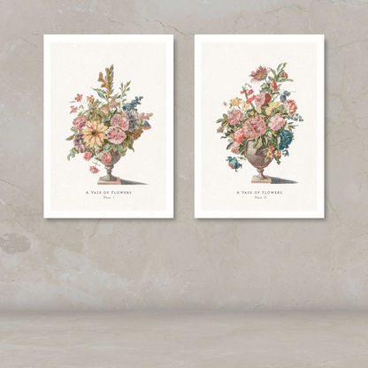 Two framed botanical art prints of flower bouquets in urns, displayed side by side on a textured beige wall above a light floor.
